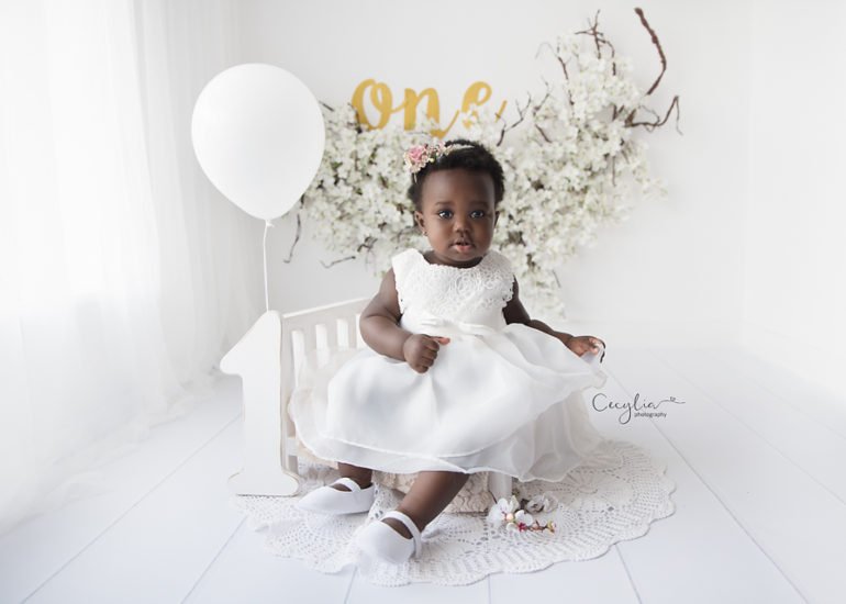 one year old baby in white dress