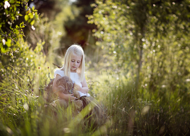 a baby girl with her toy in the park