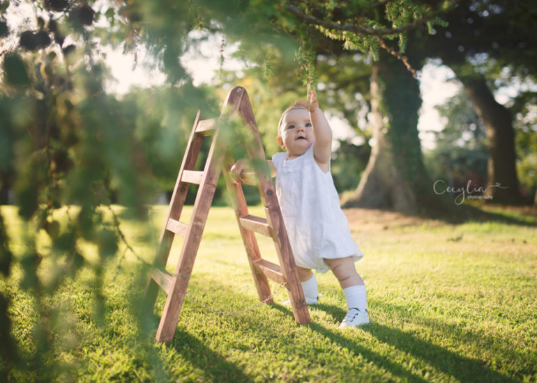 a small baby in the park with ladder