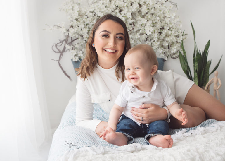 happy mother with her baby on the bed