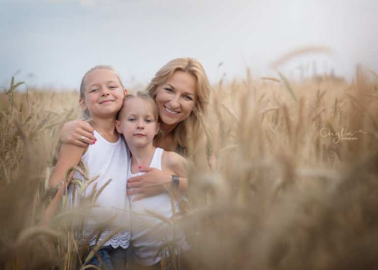 happy mother with two daughters on the field