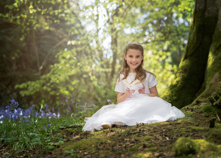 a girl in white dress holy communion photo session