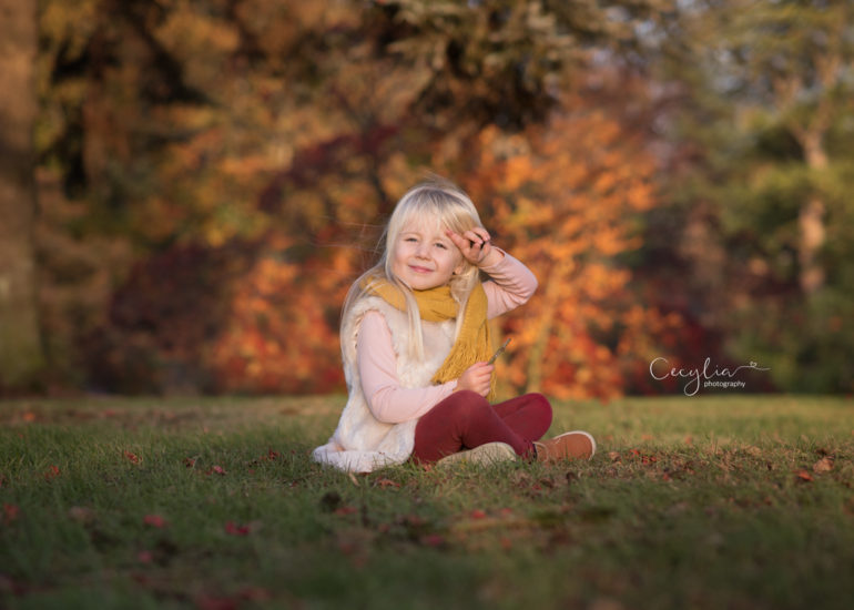kids photographer captured baby siting on the grass in park