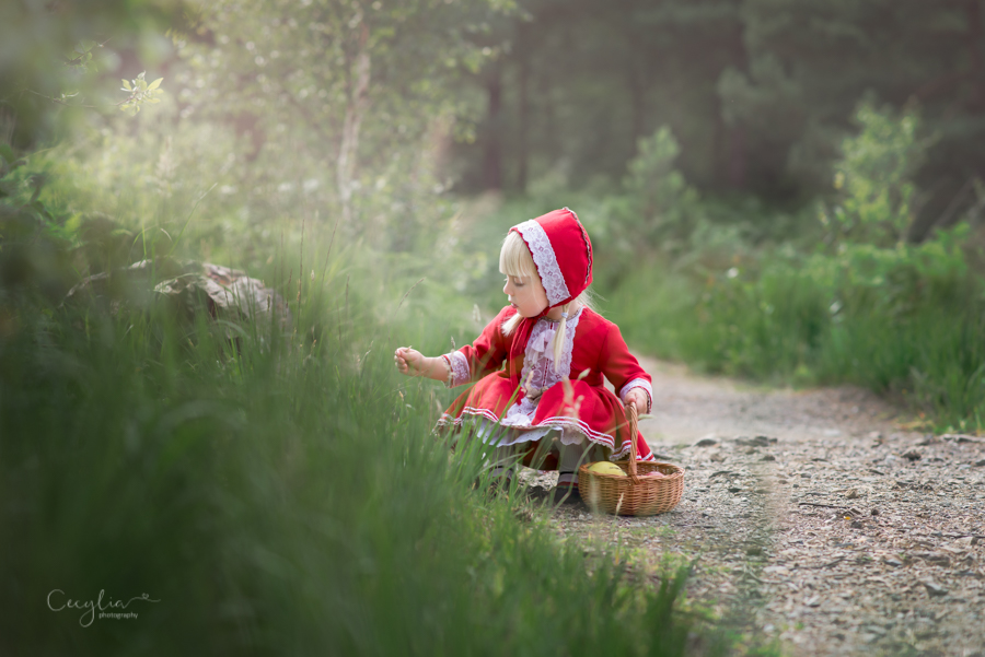 a baby in red dress in the park