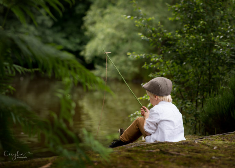 a boy holding a fishing rod