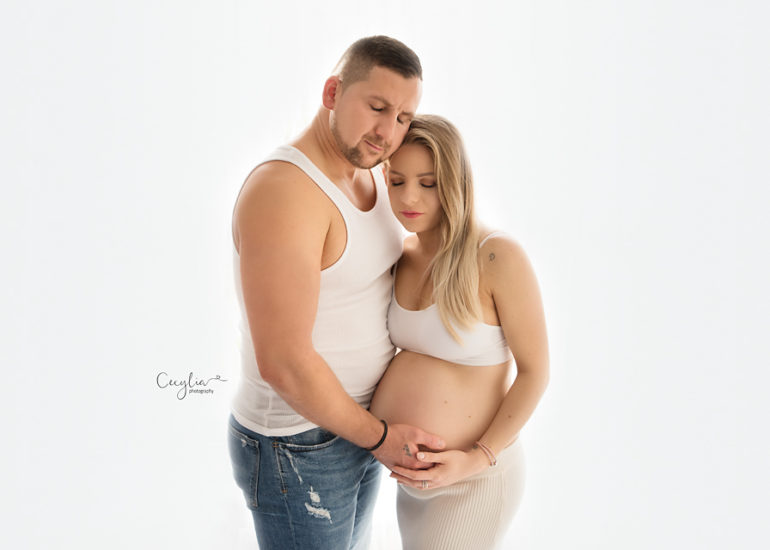 a couple expecting a baby posing together