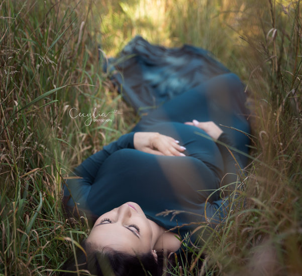 lady expecting a baby laying on the ground