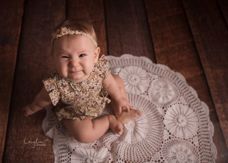 a baby girl smiling to the camera