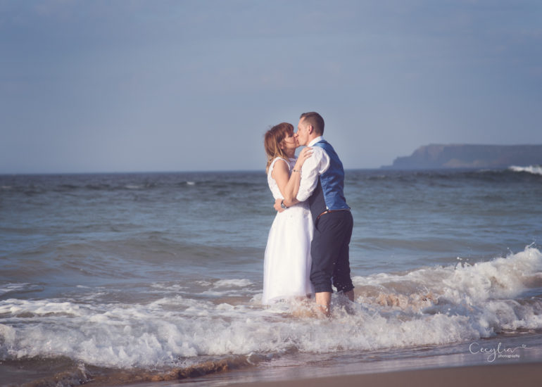 a couple kissing in the water just married